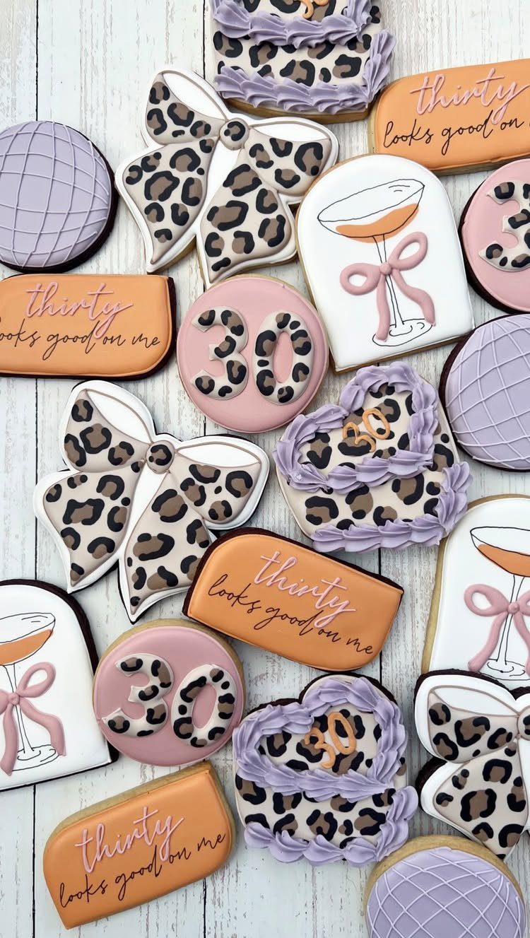 Assorted royal icing sugar cookies with leopard print and 30th birthday themes.