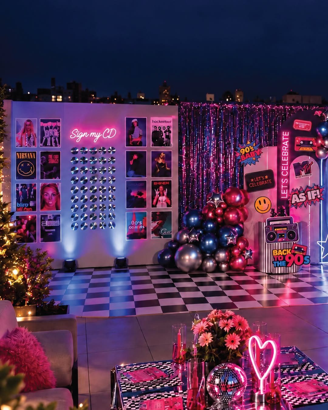 90s themed party setup with checkered floor, CD wall, and neon lighting