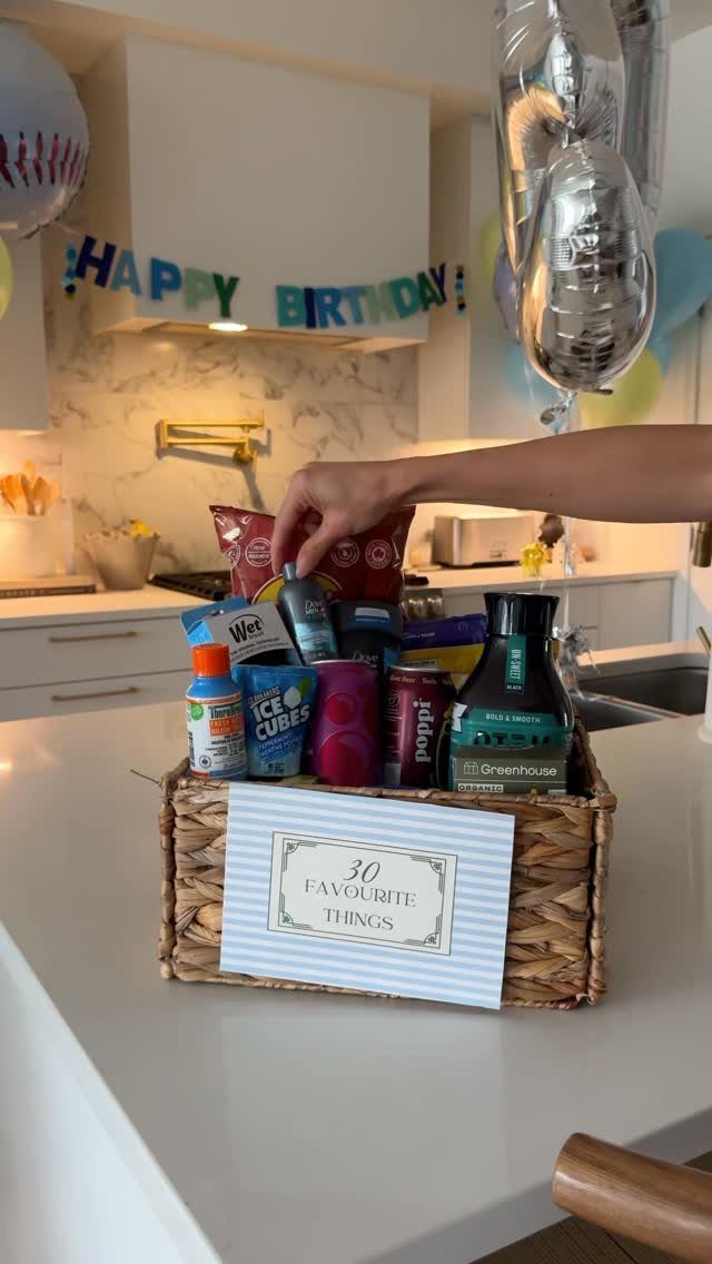 Wicker gift basket filled with snacks and a 30 Favourite Things sign