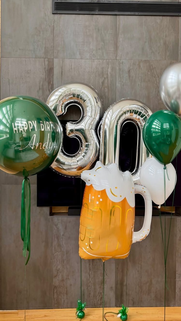 Silver number 30 balloons and a beer mug balloon for a birthday celebration.