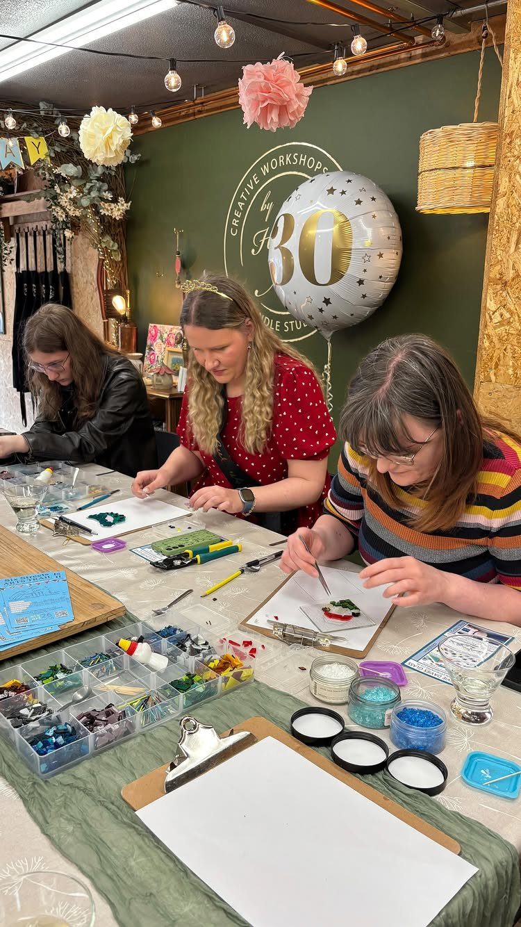 Three women crafting at a table with a silver 30th birthday balloon.