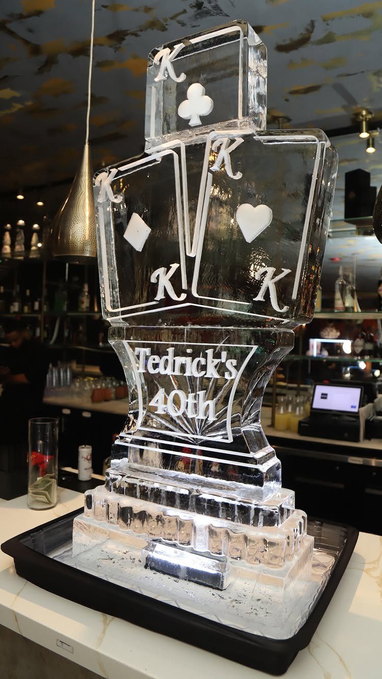 Ice sculpture of playing cards engraved with Tedrick's 40th on a bar counter
