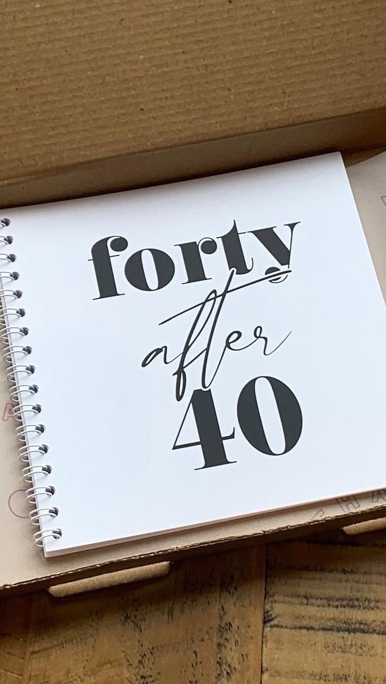 Spiral-bound notebook with 'forty after 40' text inside a cardboard shipping box.