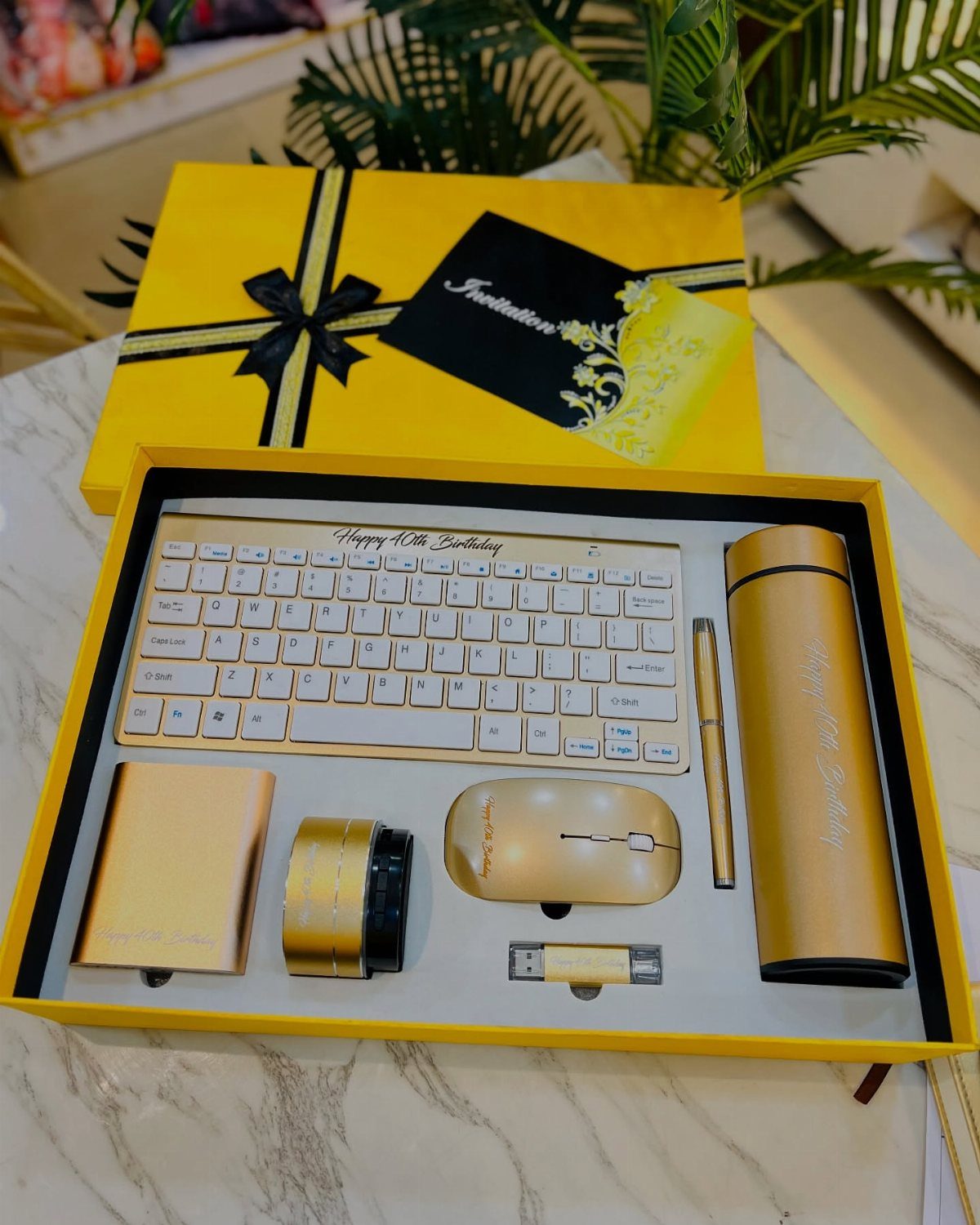 Gold electronics gift set with keyboard and mouse in a yellow box