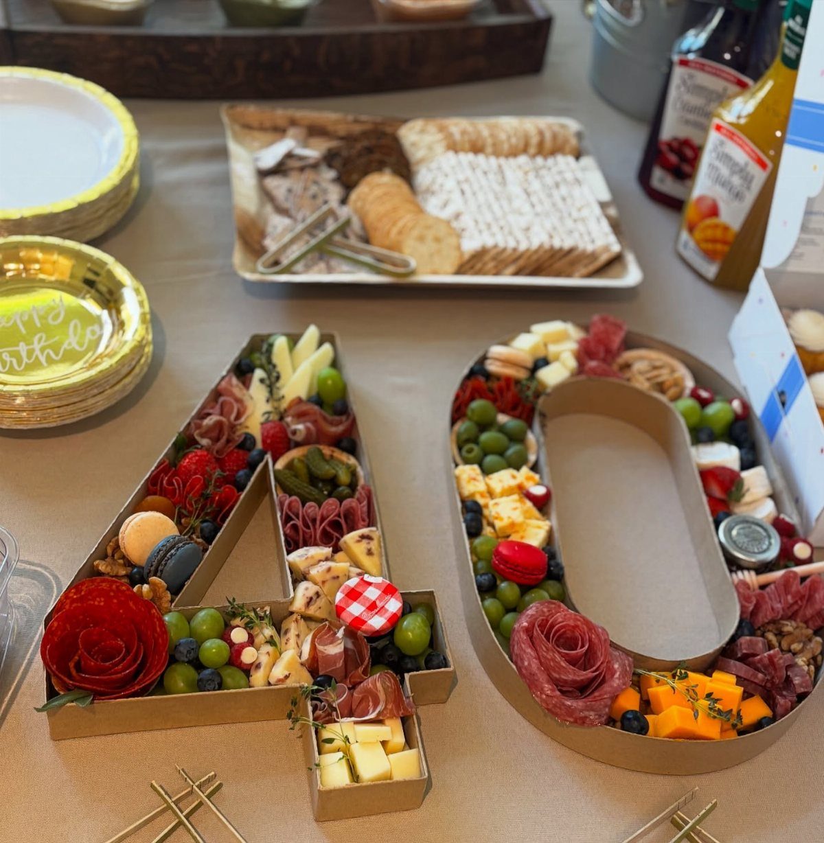 Charcuterie board arranged as the number 40 with meats, cheeses, and fruits.