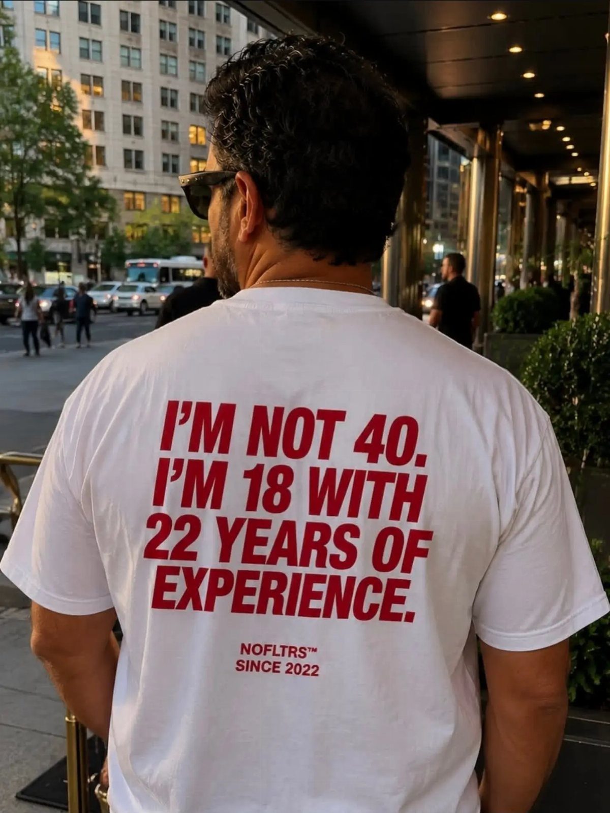 Man wearing a white t-shirt with a funny 40th birthday quote in red
