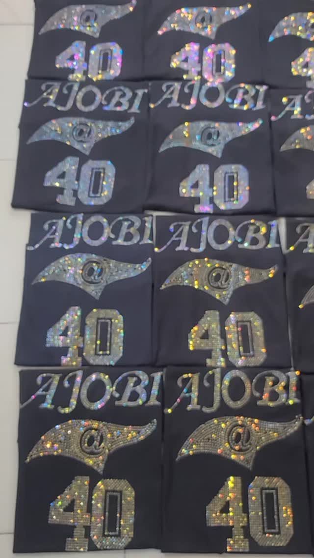 Dark grey t-shirts with shimmering rhinestone designs featuring the number 40 and AJOBI.