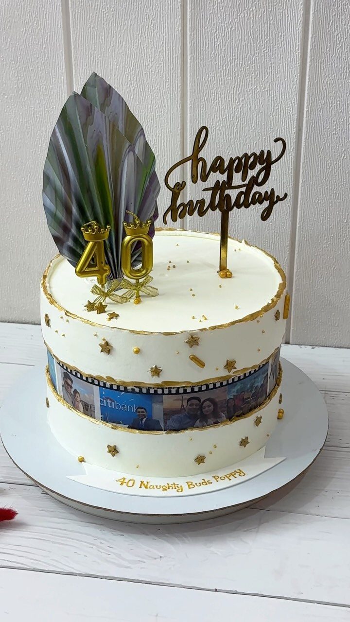 White birthday cake with a photo film strip, gold 40 topper, and stars.