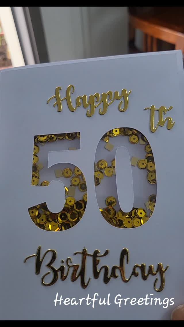 Light blue 50th birthday card with gold lettering and gold sequin filled numbers.