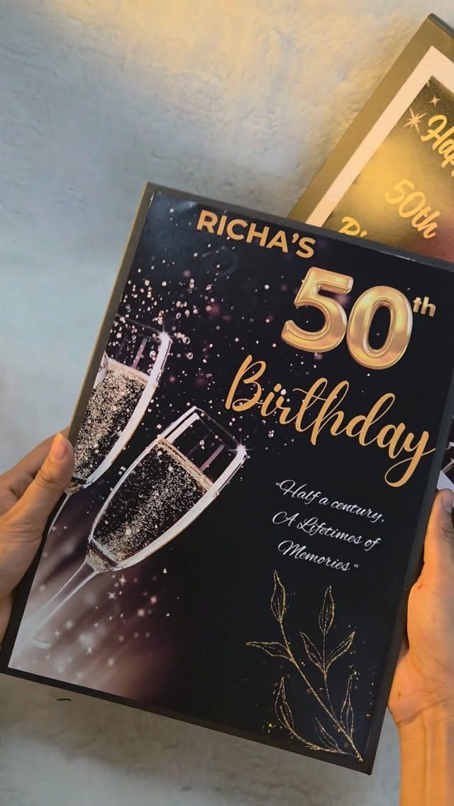 Black 50th birthday card for Richa with gold text and champagne glasses.
