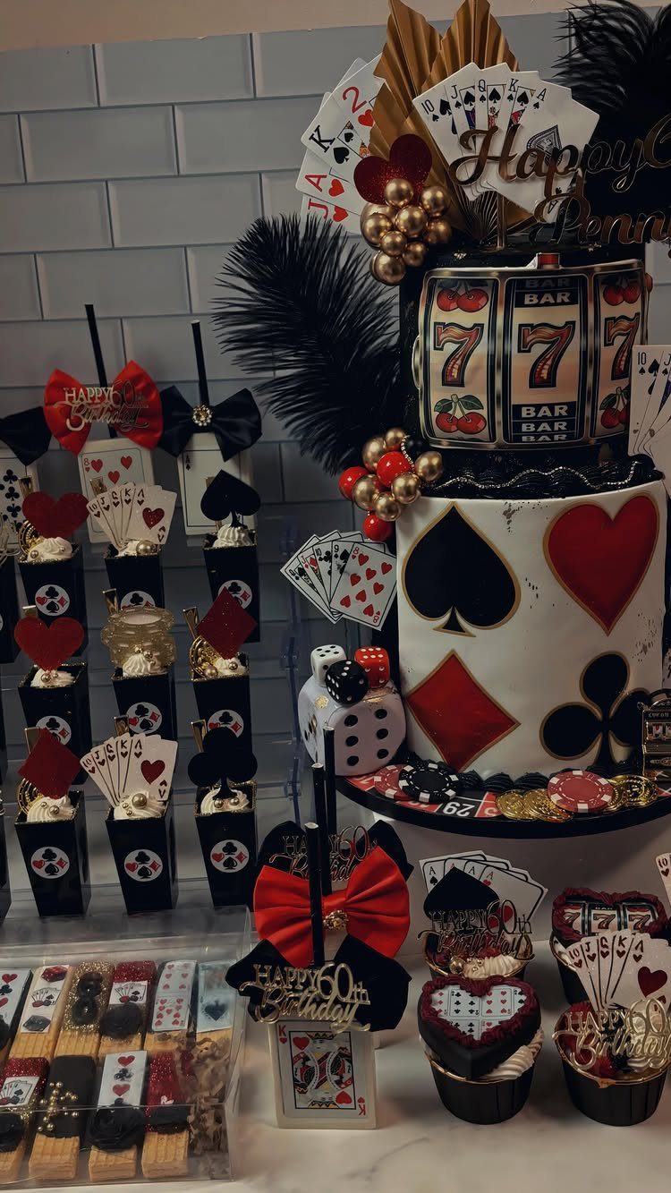 Casino themed birthday cake and desserts with playing cards, dice, and gold accents.
