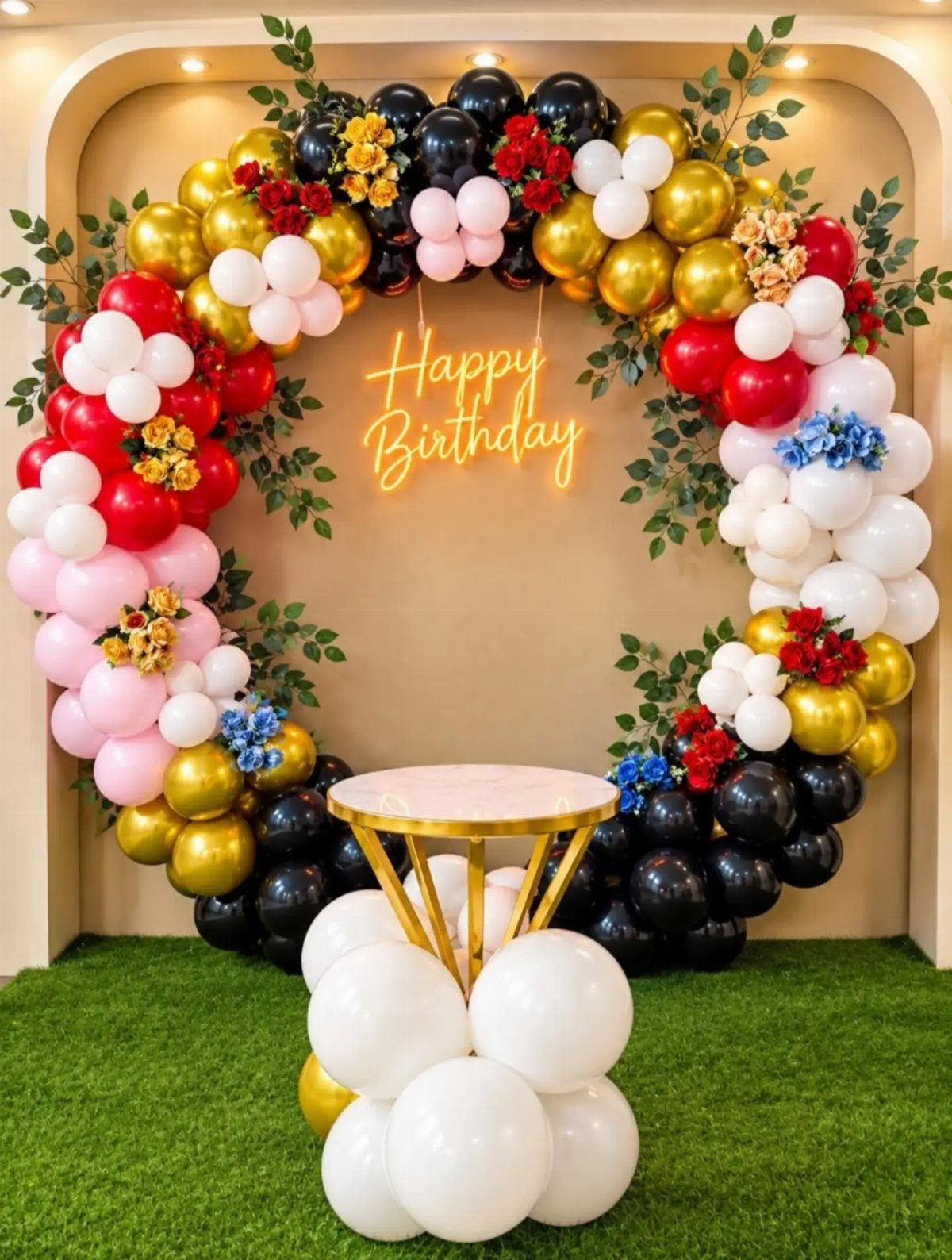 Circular balloon arch with neon Happy Birthday sign and a small gold table.