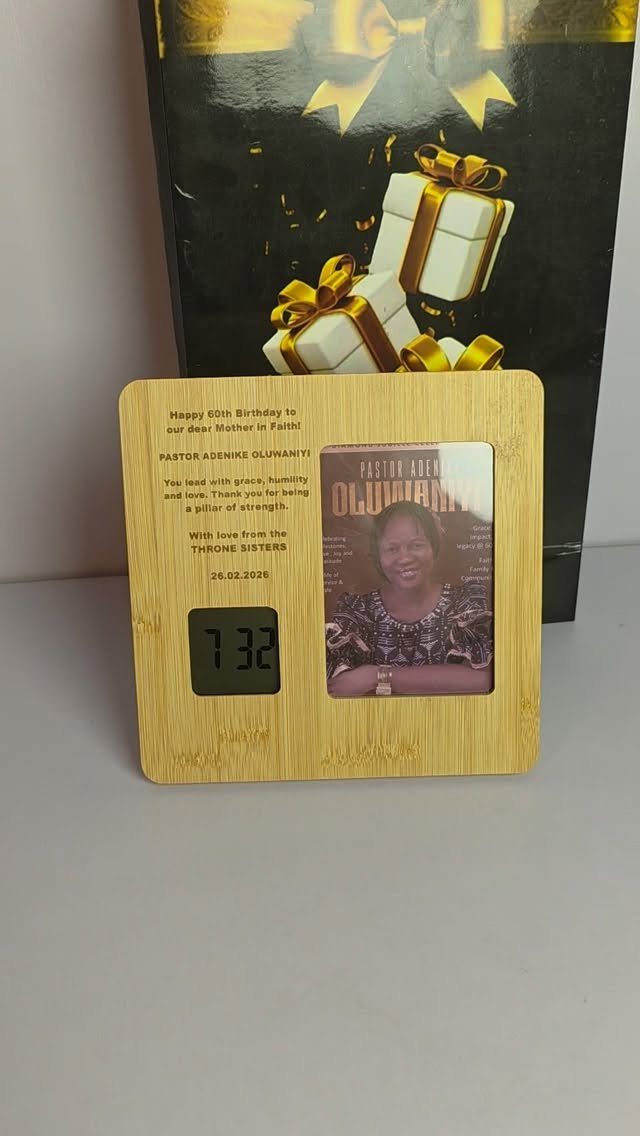 Personalized bamboo digital clock with a woman's photo for a 60th birthday gift.