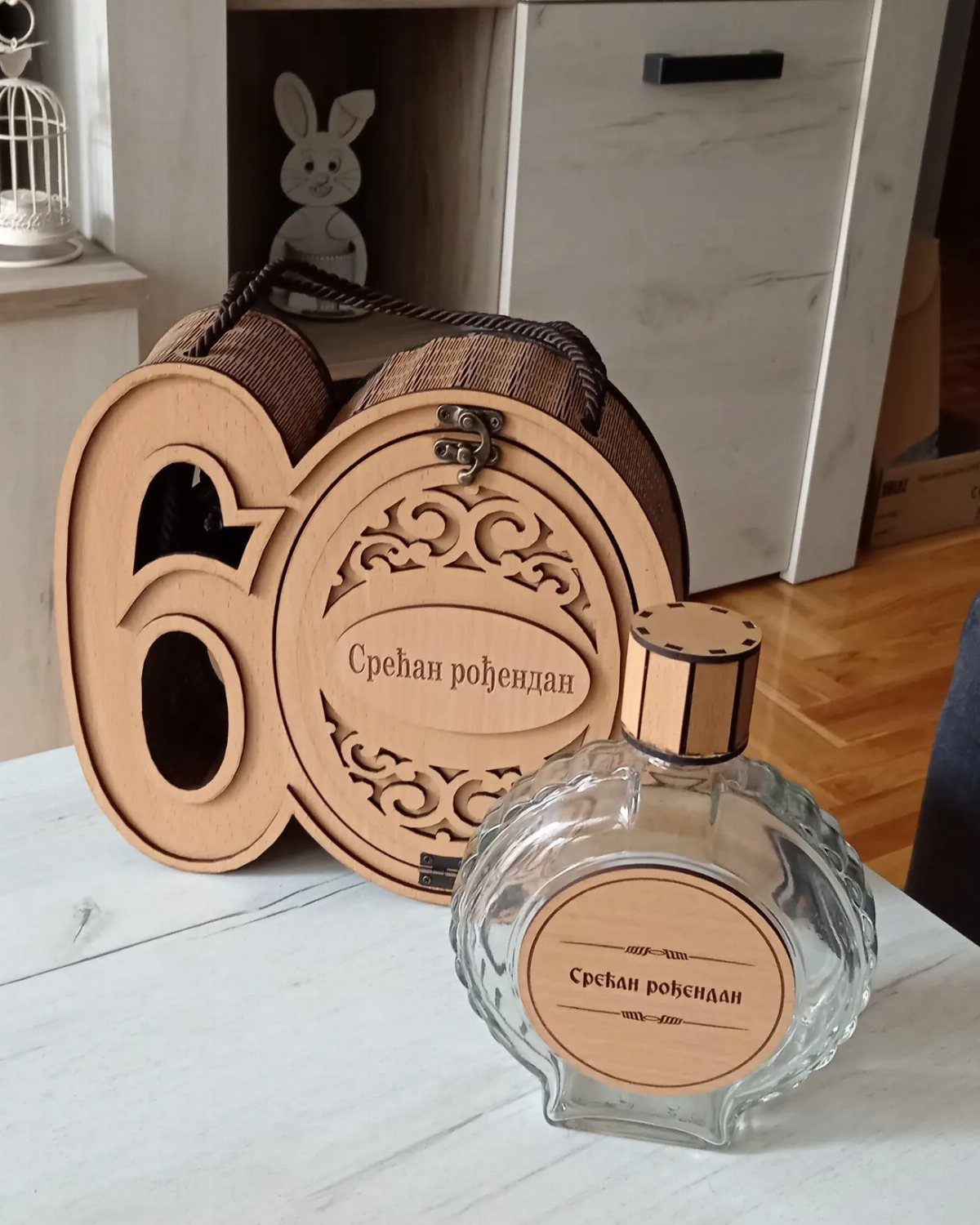 Wooden gift box shaped like number 60 and a glass decanter with labels.