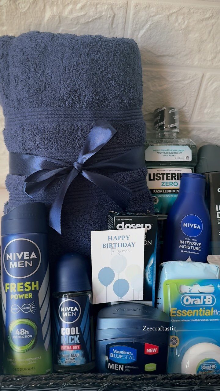 Grooming kit with navy towel, Nivea products, and a Happy Birthday card.