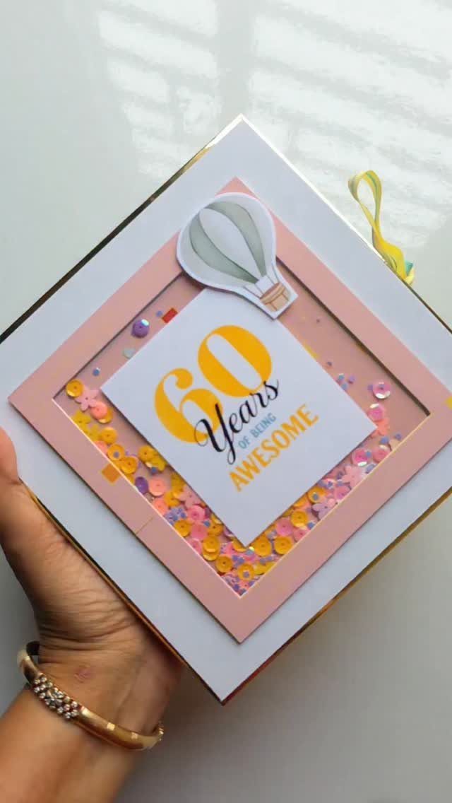 Handmade 60th birthday card with colorful confetti and a hot air balloon illustration.