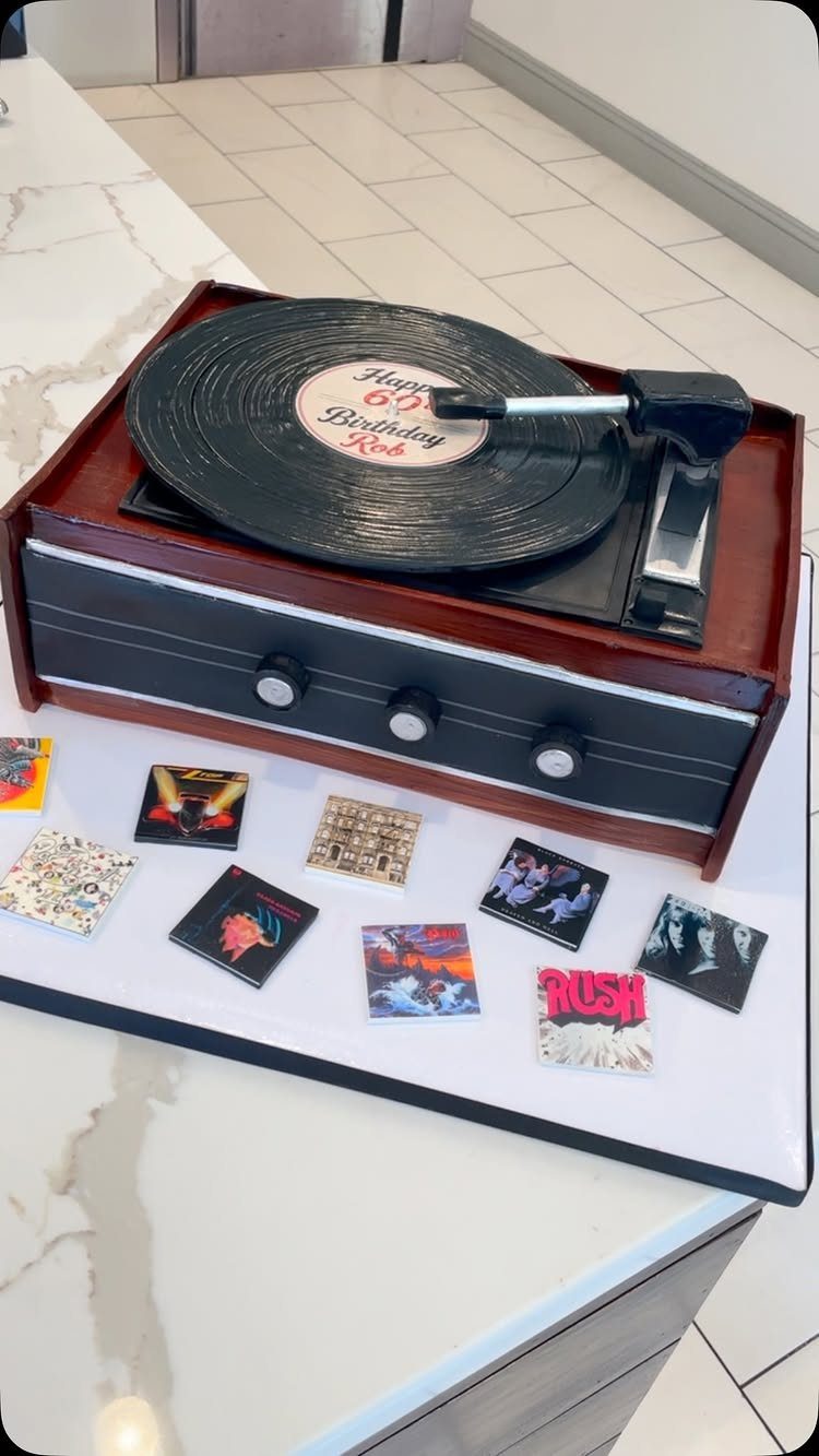 Miniature record player with 60th birthday message and small album covers