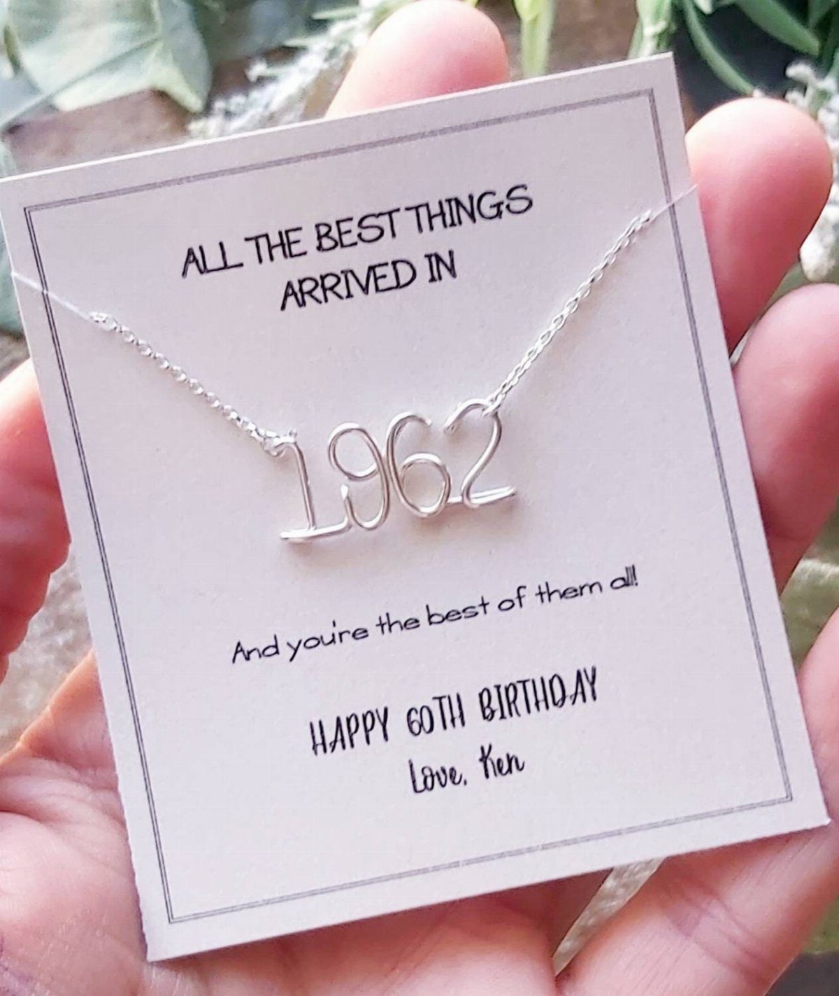 Silver necklace with 1962 pendant on a 60th birthday greeting card