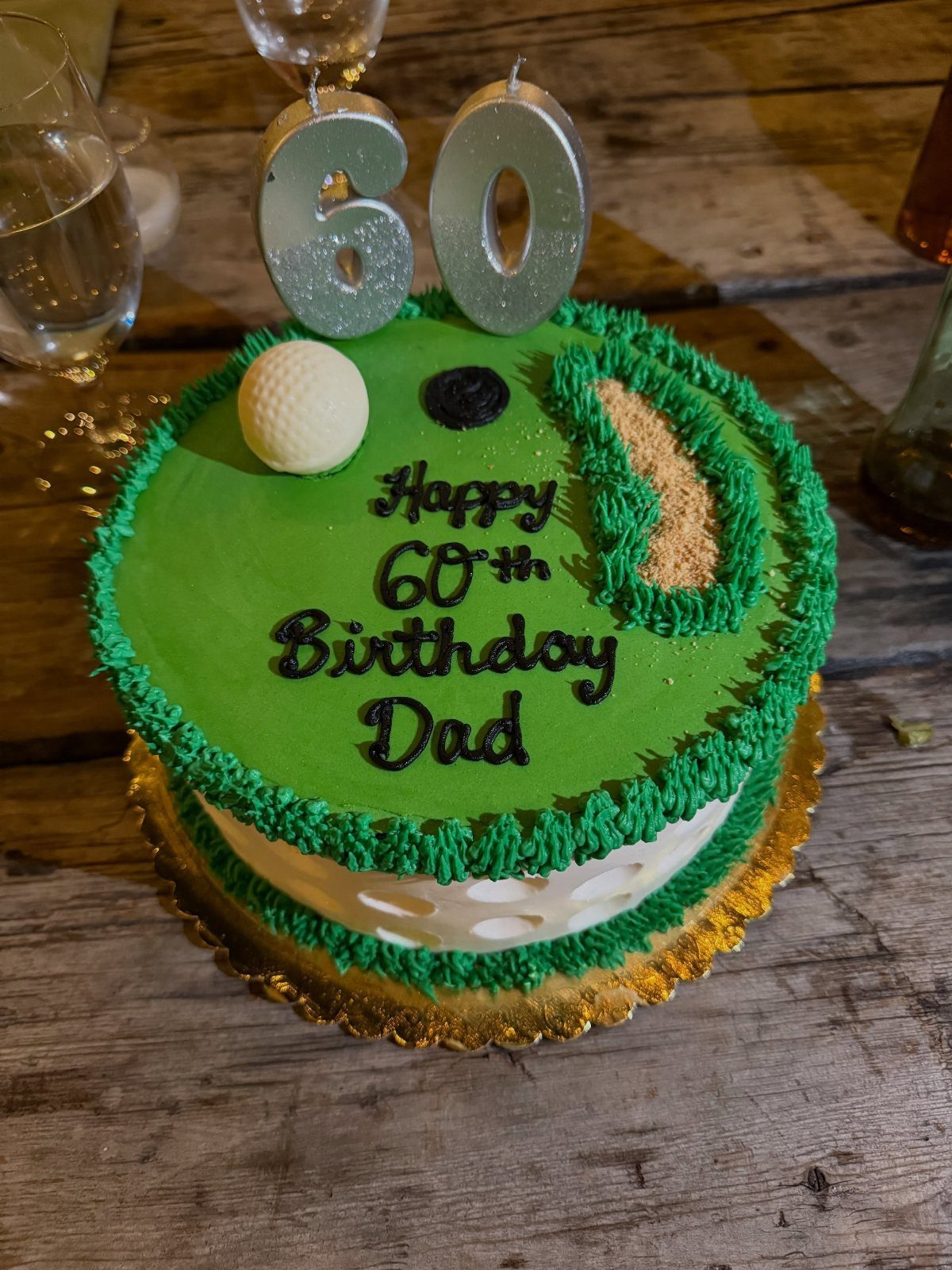 Golf themed birthday cake for a 60th birthday with green frosting and candles.
