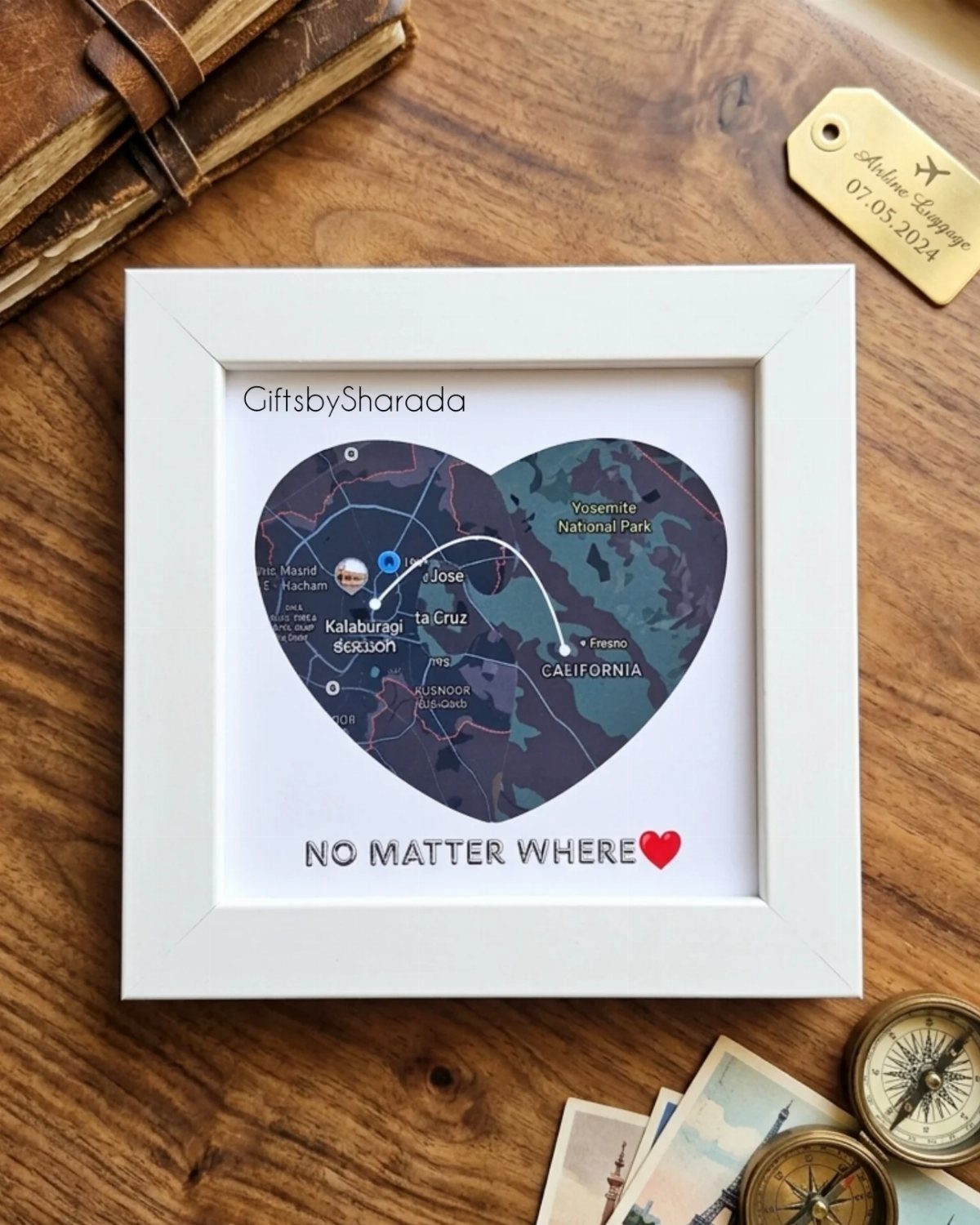 Heart-shaped map art in a white frame showing two connected locations on wood.