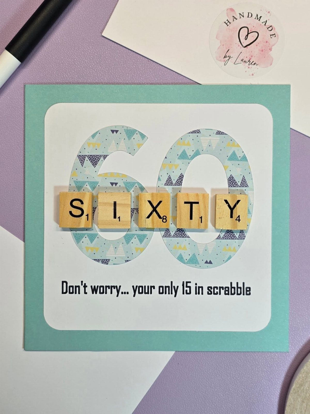 Handmade 60th birthday card featuring Scrabble tiles spelling SIXTY over a patterned number 60.