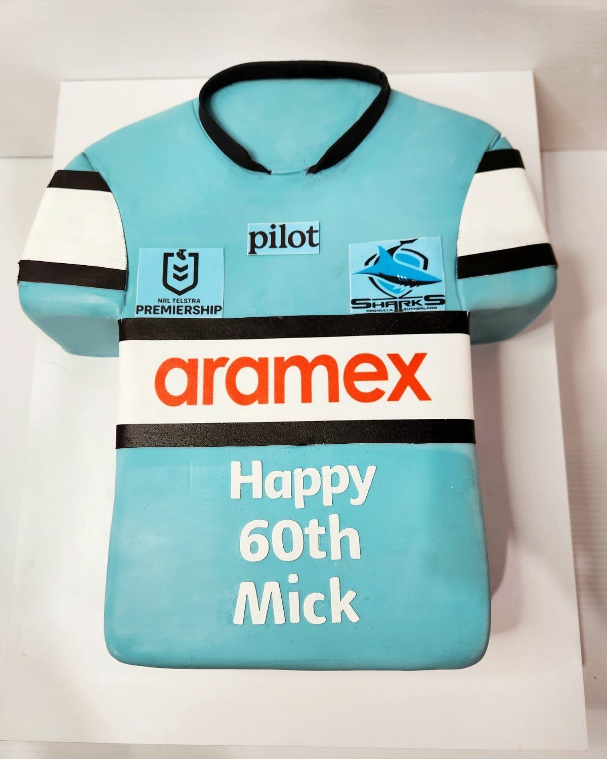 Light blue sports jersey cake with 60th birthday message for Mick.
