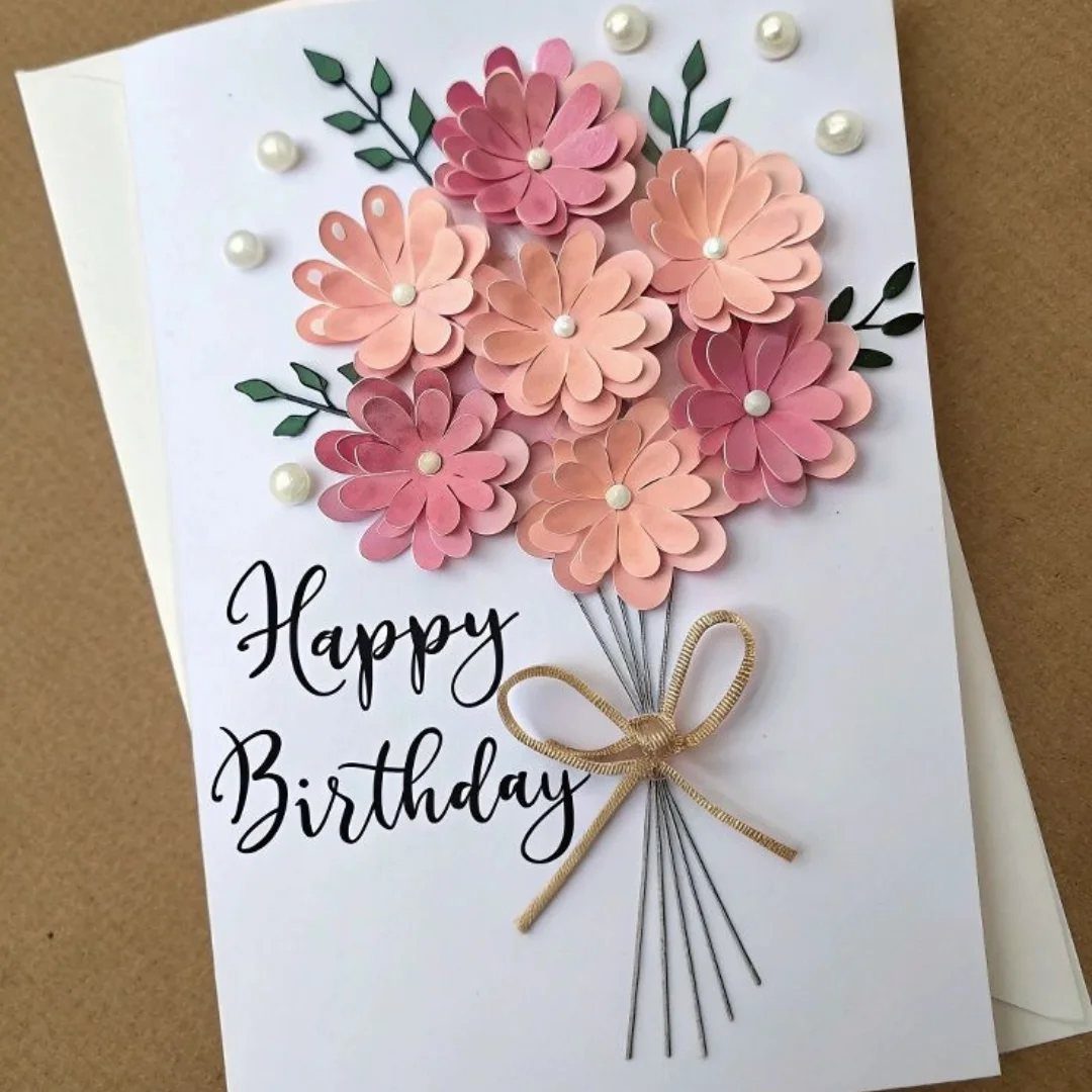 Birthday card with 3D pink paper flowers and a small twine bow.