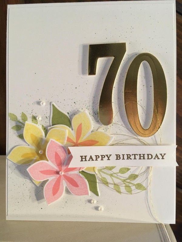 White birthday card with gold number 70 and colorful paper flowers.