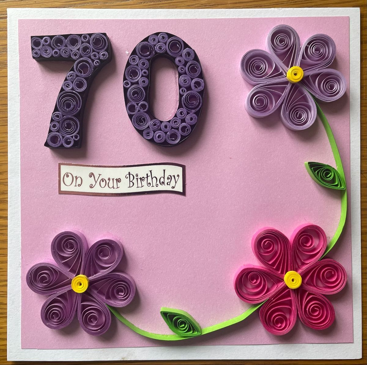 Handmade birthday card with quilled paper flowers and the number 70 on pink.