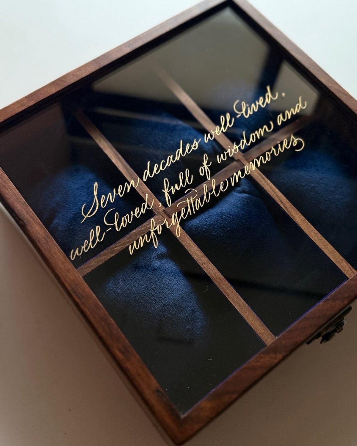 Wooden watch box with glass lid and gold engraving for a 70th birthday.