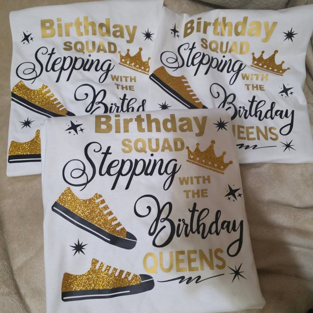 Three white t-shirts with gold glitter sneakers and birthday squad text designs.