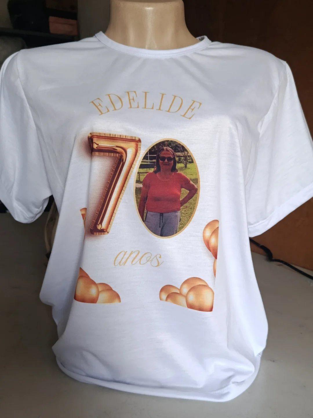 White t-shirt with gold 70th birthday design, name, and photo of a woman.