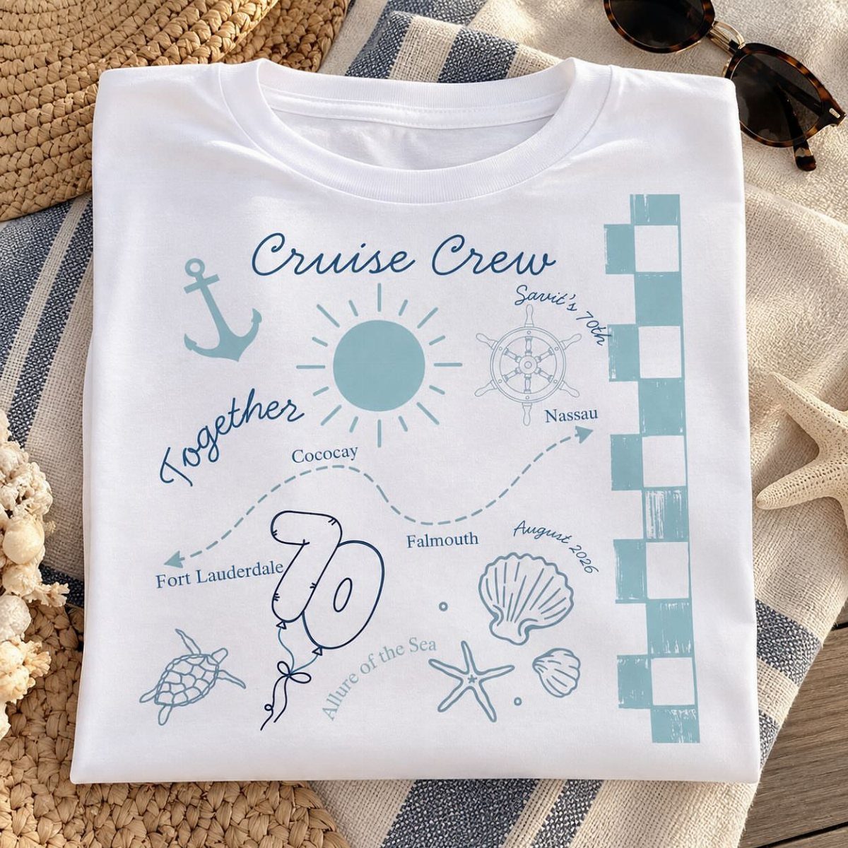 White t-shirt with light blue cruise theme graphics and number 70 on towel