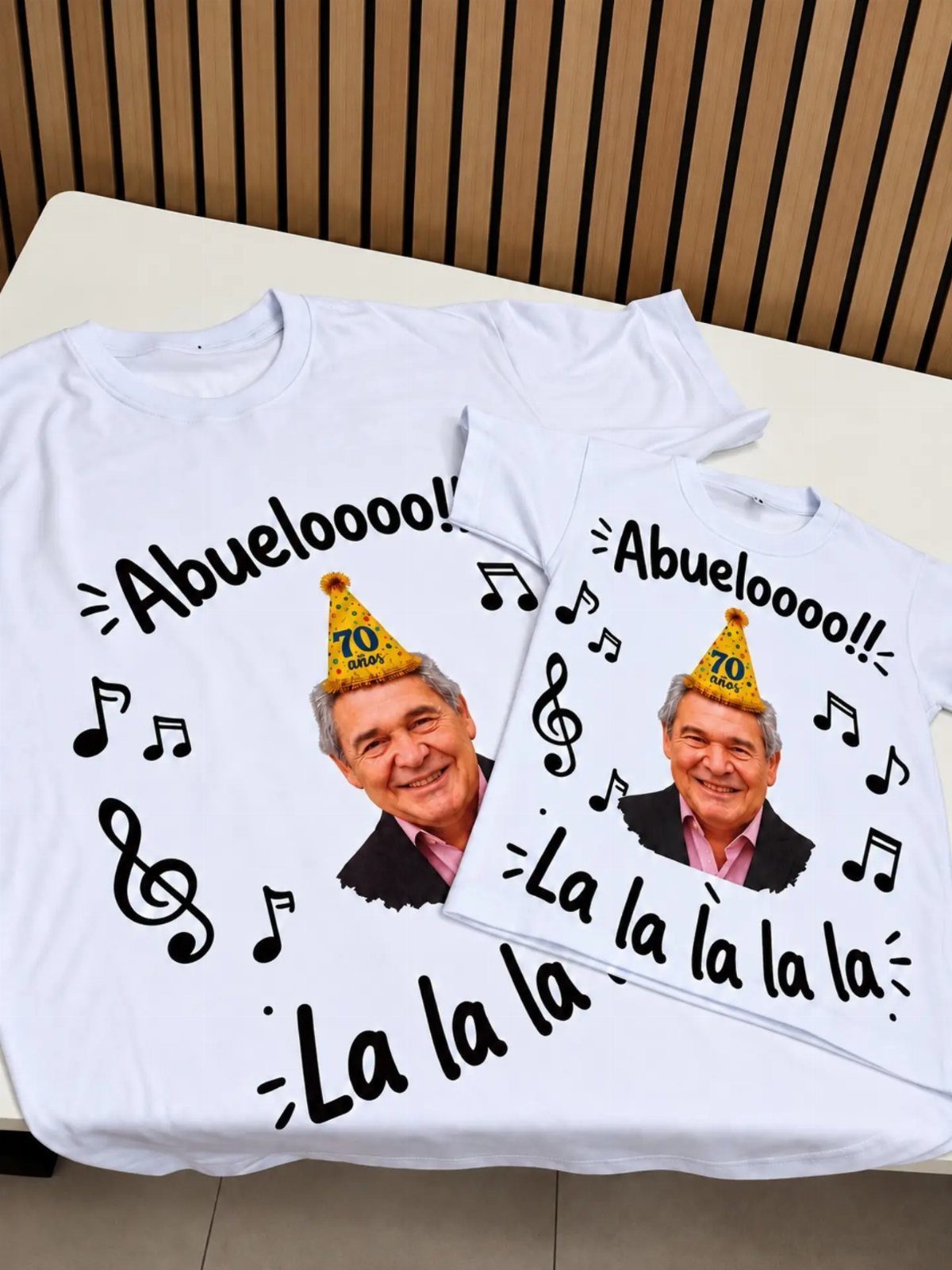 White t-shirts featuring a photo of a grandfather with musical notes and text.