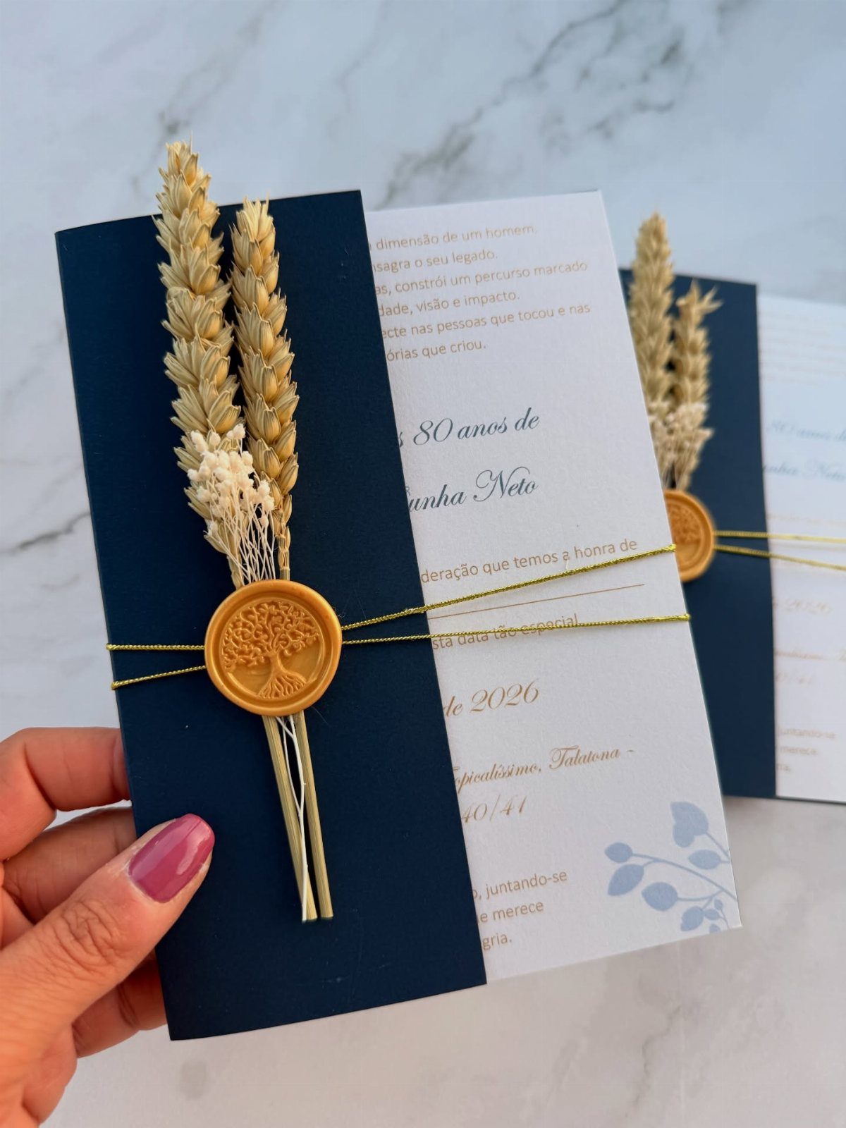 Navy blue and white 80th birthday invitation with gold wax seal and dried wheat