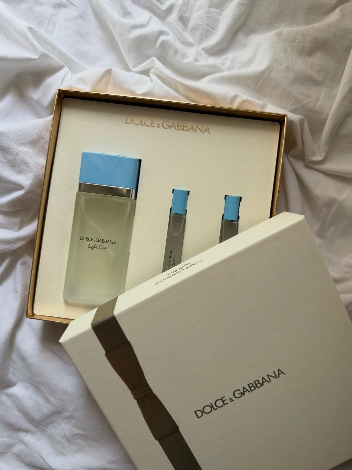 Dolce & Gabbana perfume gift set with bottles in a white and gold box.