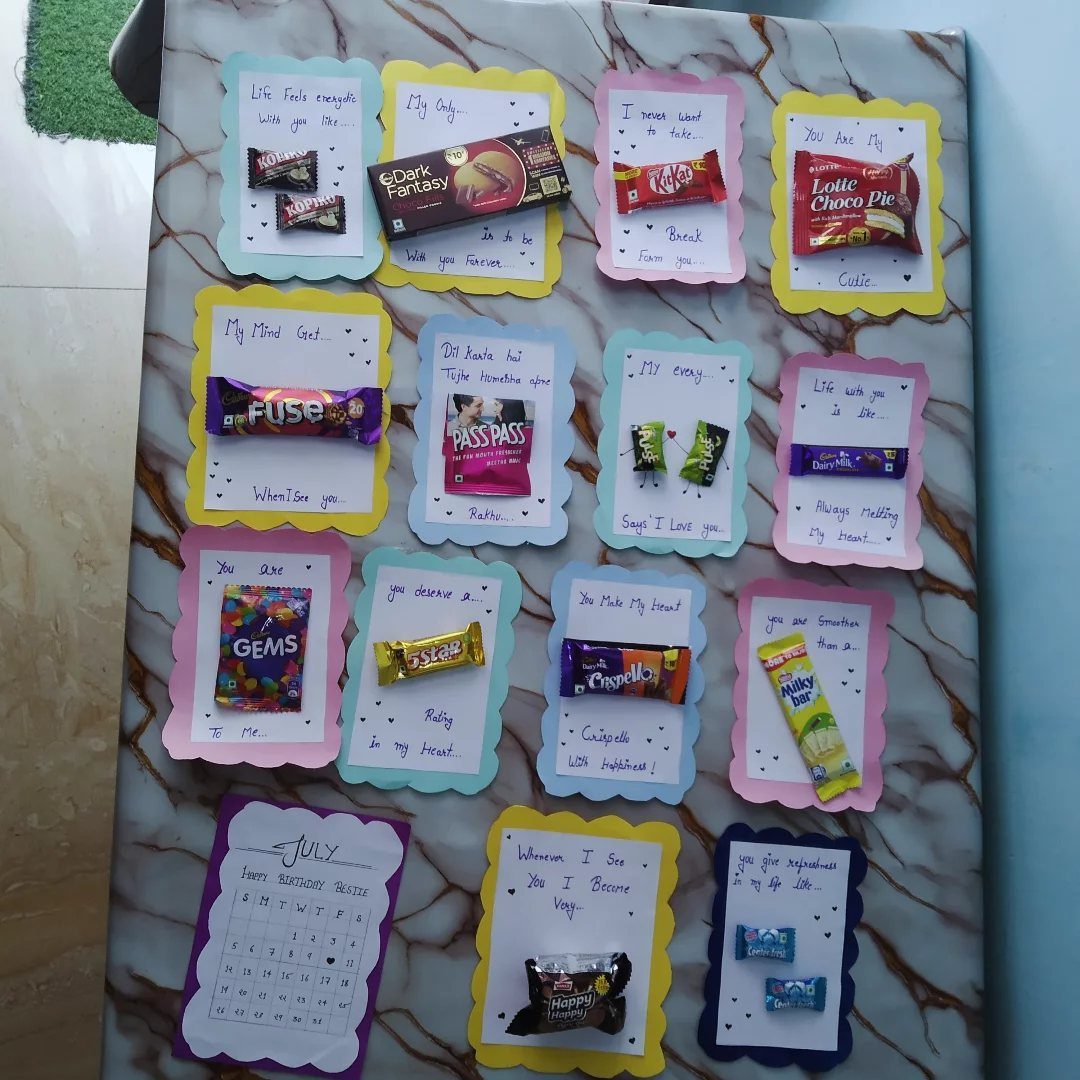 Handmade gift board with various chocolates and candies attached to colorful message cards.