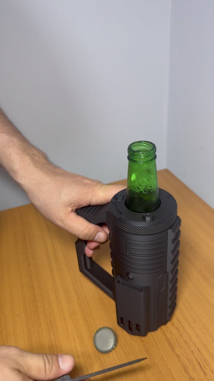 Black grenade-shaped bottle cooler holding a green glass bottle on a wooden table