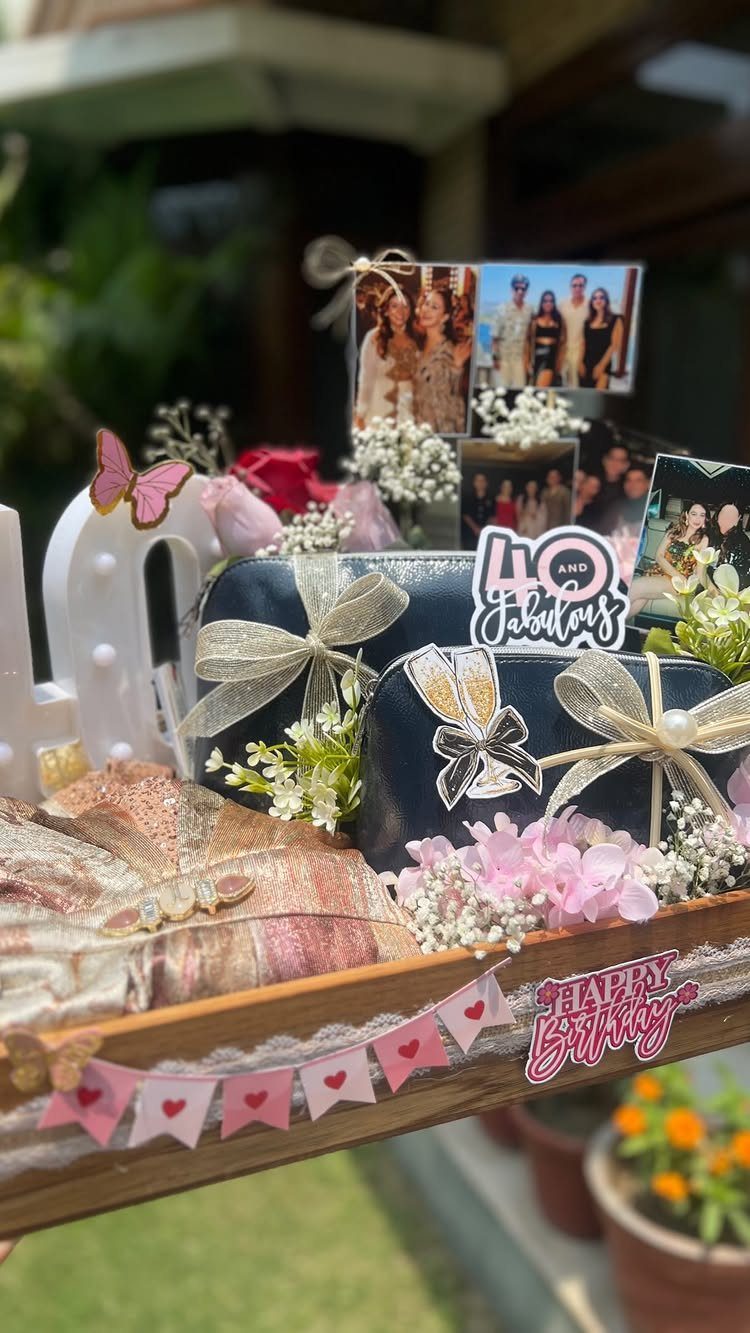 Birthday gift tray with black boxes, pink flowers, and 40 and Fabulous sign