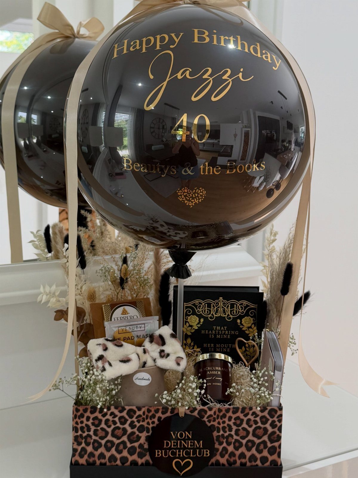 Birthday gift hamper with a black 40th birthday balloon and leopard-print box.