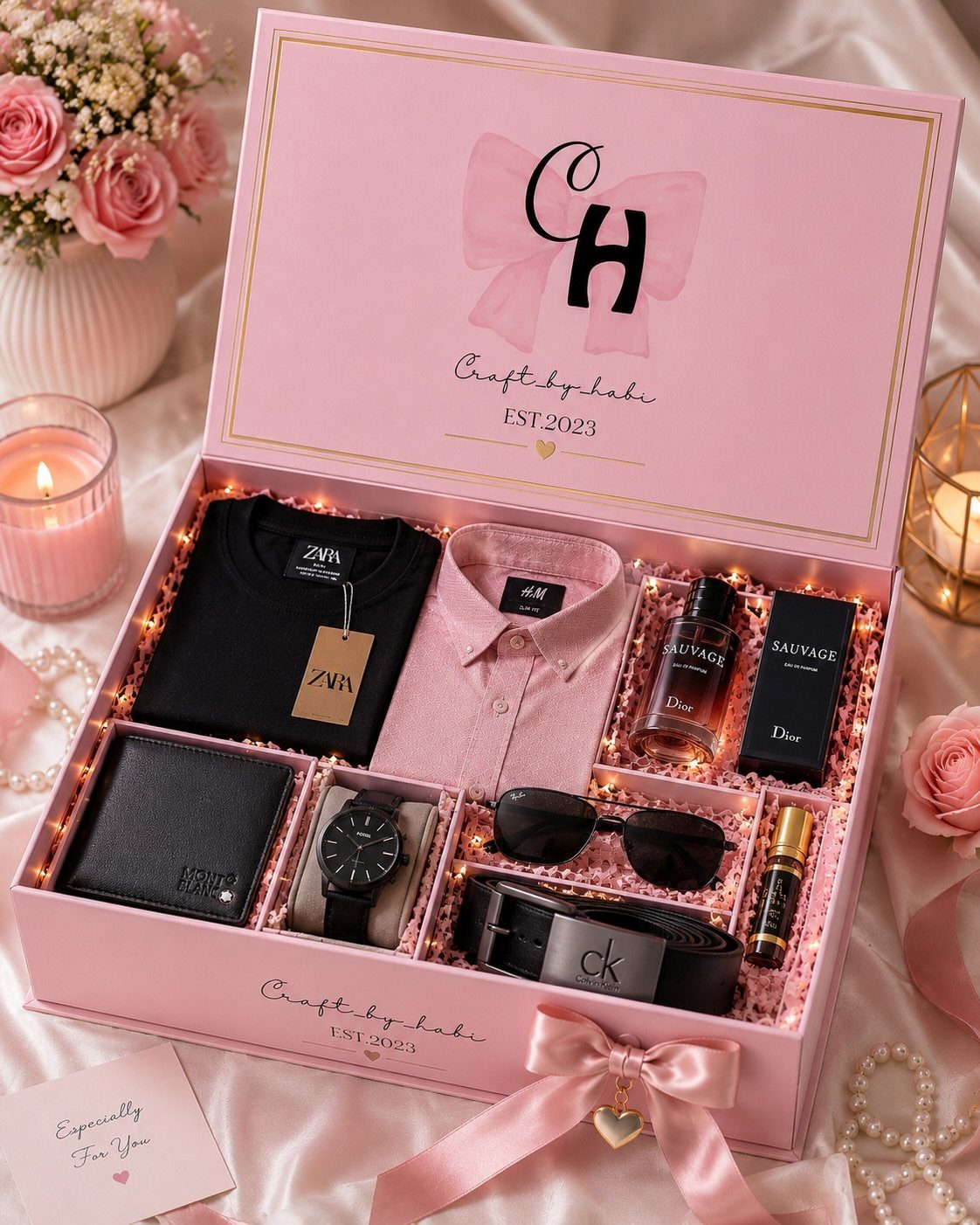 Pink gift box filled with men's clothing, accessories, and fragrance for a birthday.