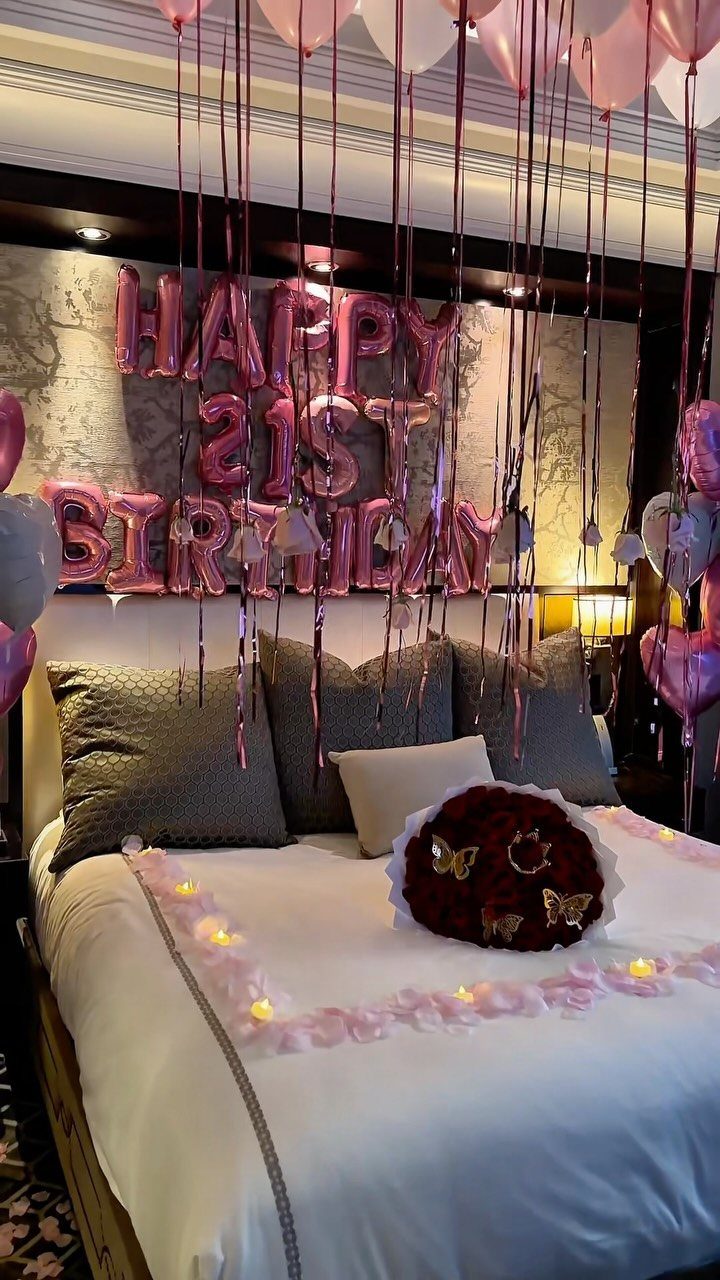 Bedroom decorated with pink balloons and foil letters spelling Happy 21st Birthday.