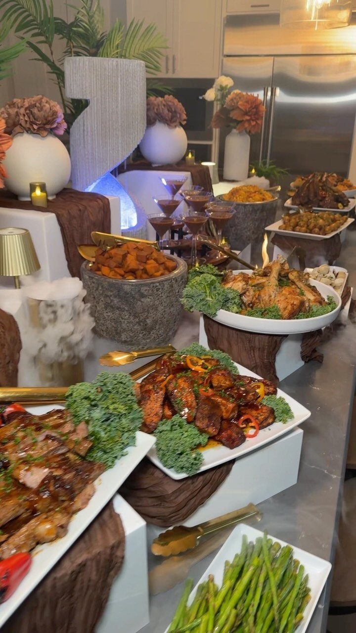 Gourmet buffet spread with steak, ribs, and asparagus on a decorated party table.