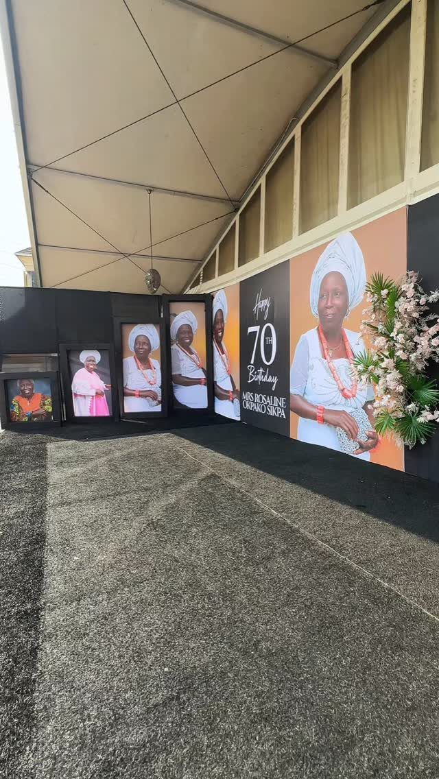 Birthday display with large portraits of a woman celebrating her 70th birthday.