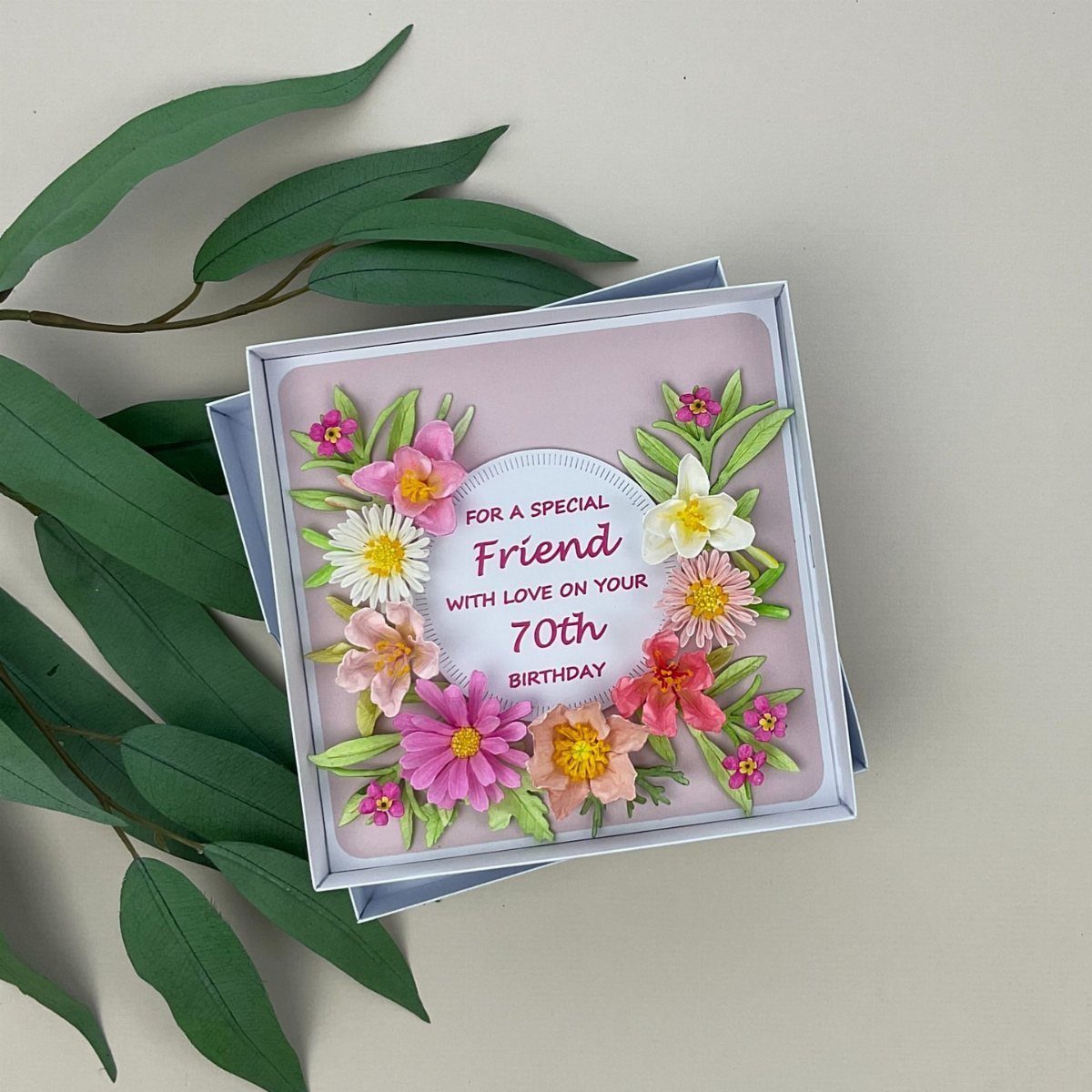 Handmade 70th birthday card with colorful 3D paper flowers and celebratory text.