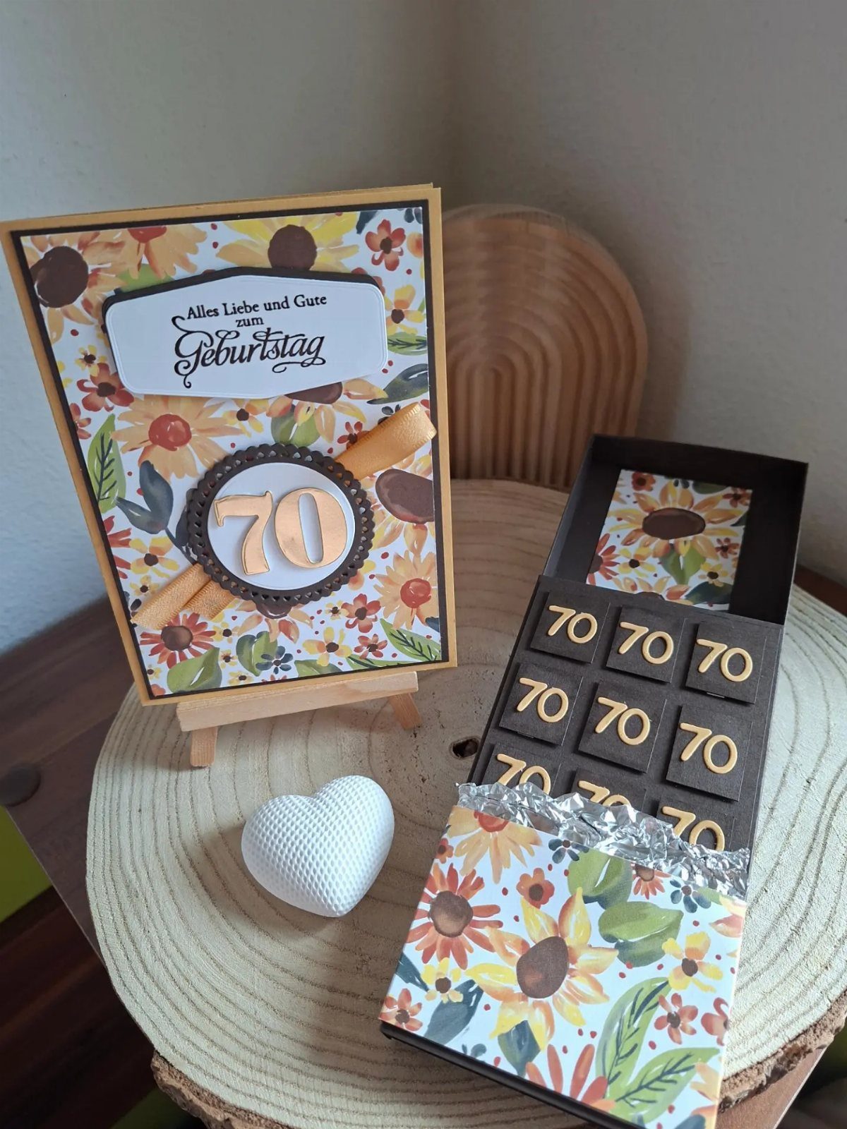 Birthday card and chocolate bar with sunflowers and the number 70 on wood