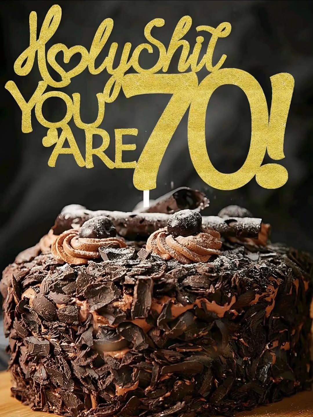 Chocolate cake with gold glitter topper saying Holy Shit You Are 70!