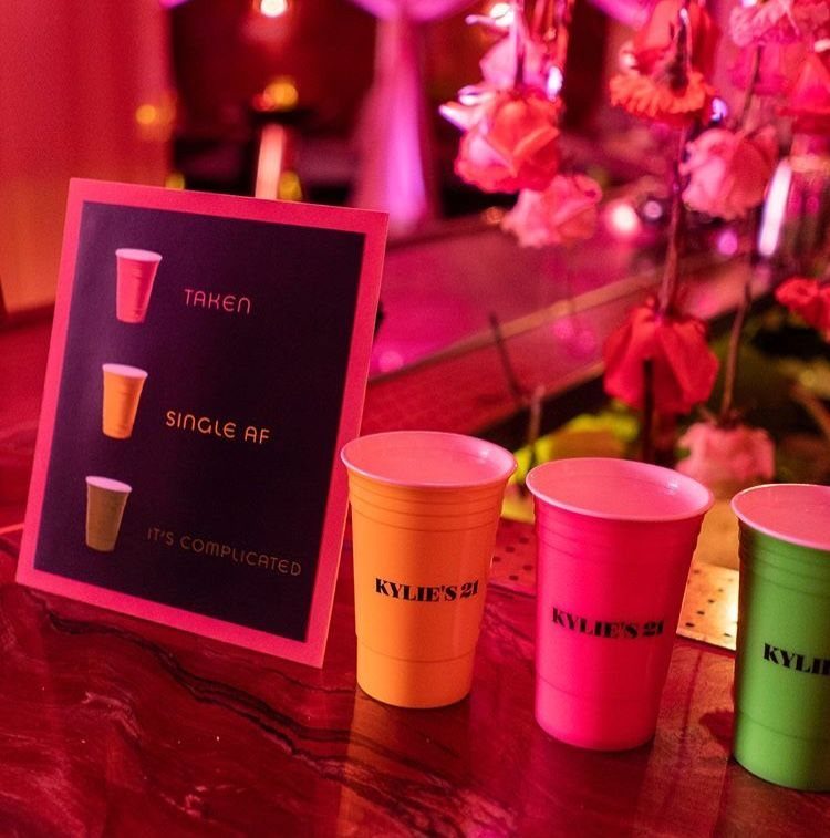 Colored plastic cups and a relationship status sign at Kylie Jenner's 21st birthday.