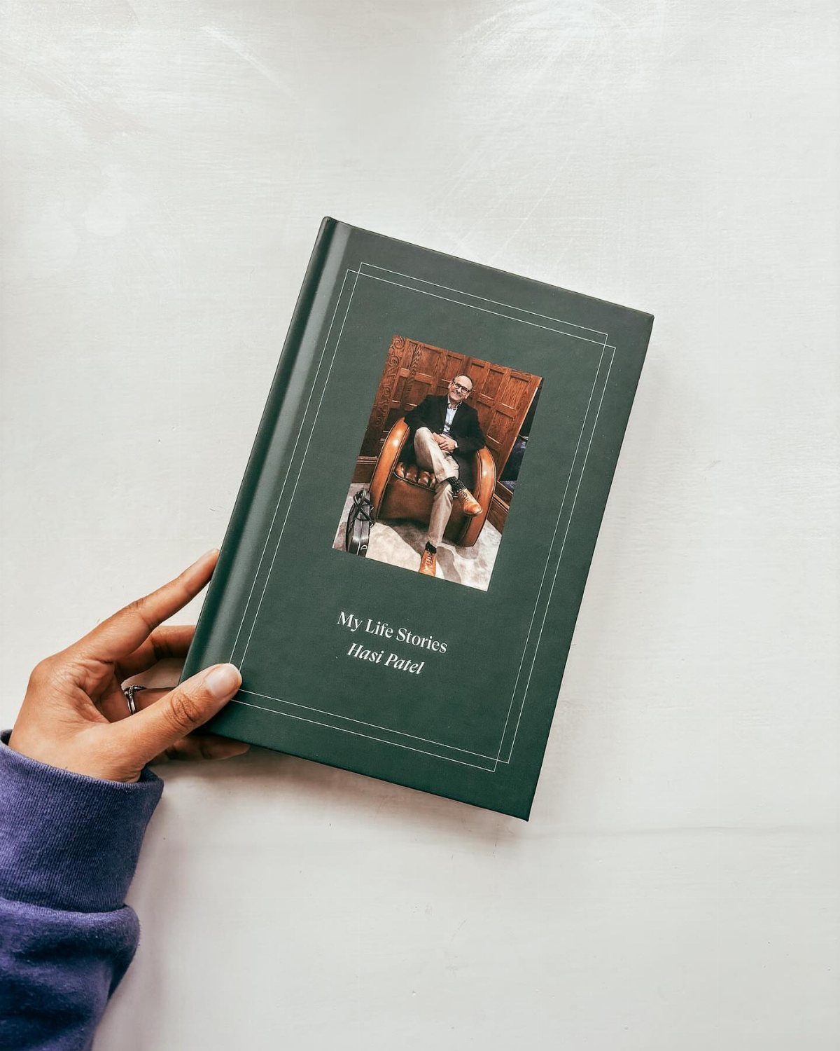 Dark green keepsake book titled My Life Stories featuring a photo of a man.