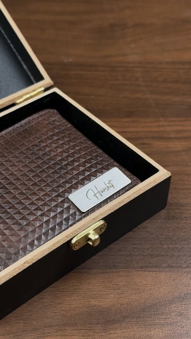 Black wooden gift box with brown leather interior and engraved silver plaque.